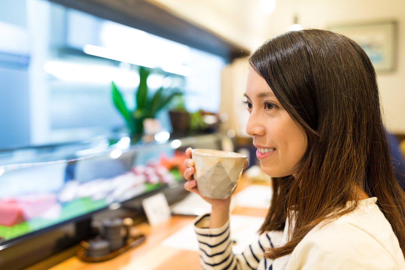 Woman having tea in japanese restaurant
