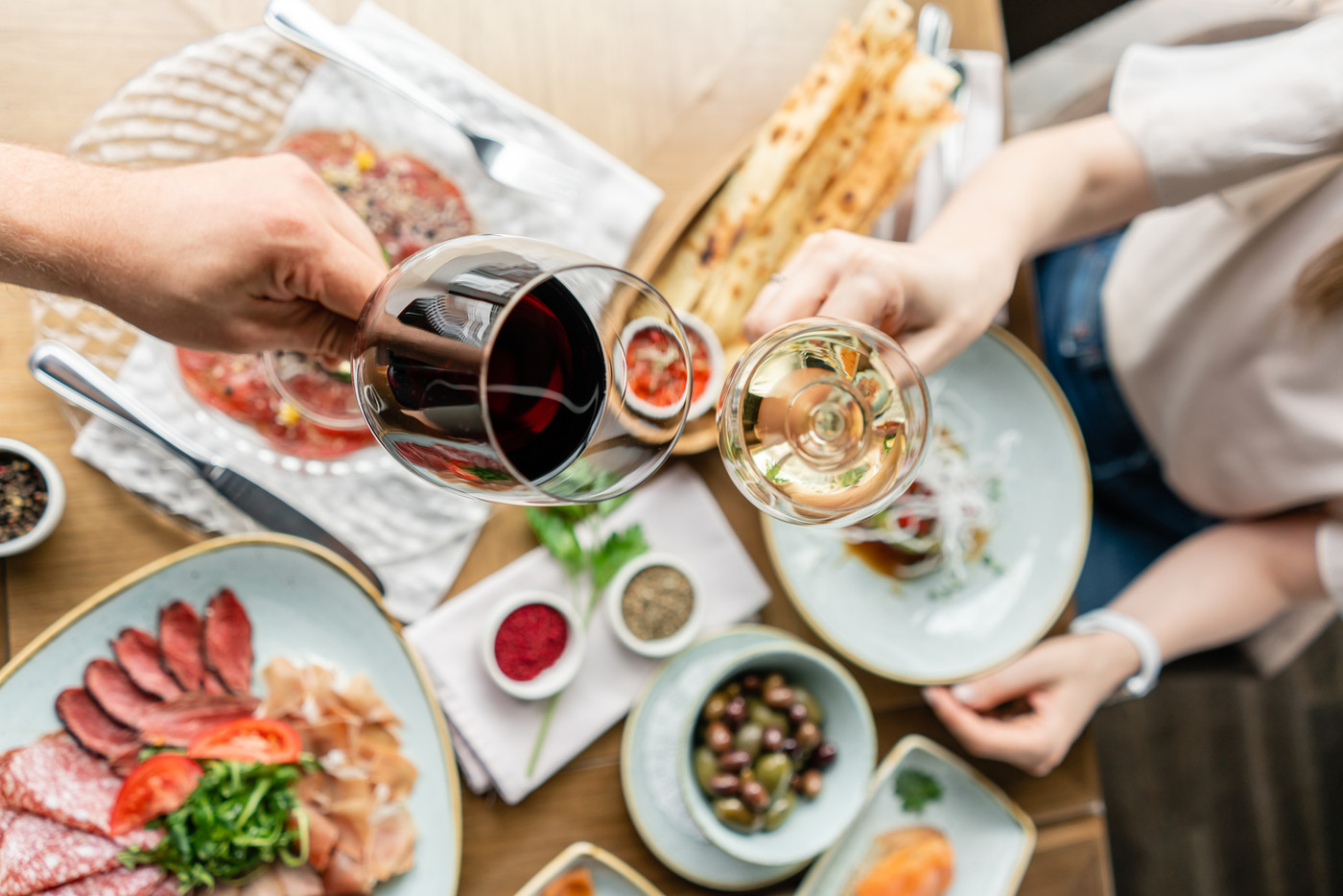 Date, man and woman Clink wine glasses. Beautiful young elegant woman in the restaurant with a wine