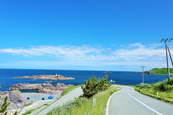 Road in Oga Peninsula under blue sky in Akita