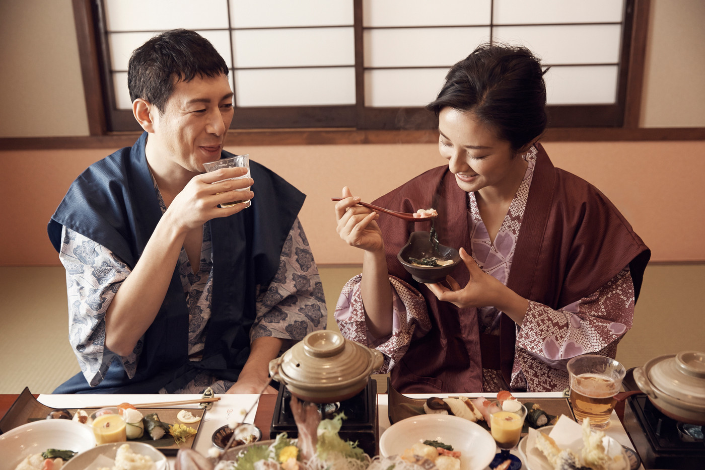 旅館で食事をする夫婦