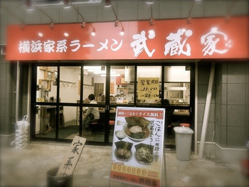 「武蔵家 東小金井店」外観 757764 横浜家系ラーメンの赤い看板と『家系中』の木の札が目立ちます。