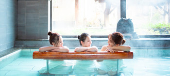 A woman and her friends enjoying an open-air bath