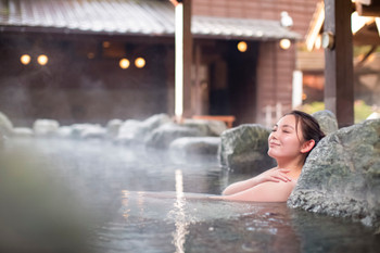 A woman enjoying an open-air bath