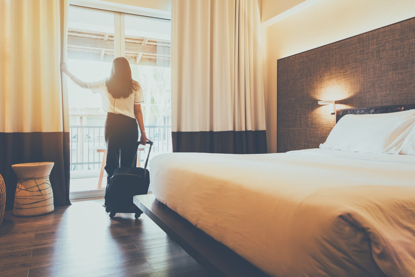 Asian women are staying in a hotel room. Open the 