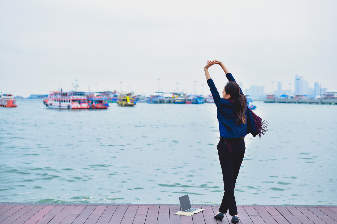 Take off work concept. Young businesswoman is cheerful at the se