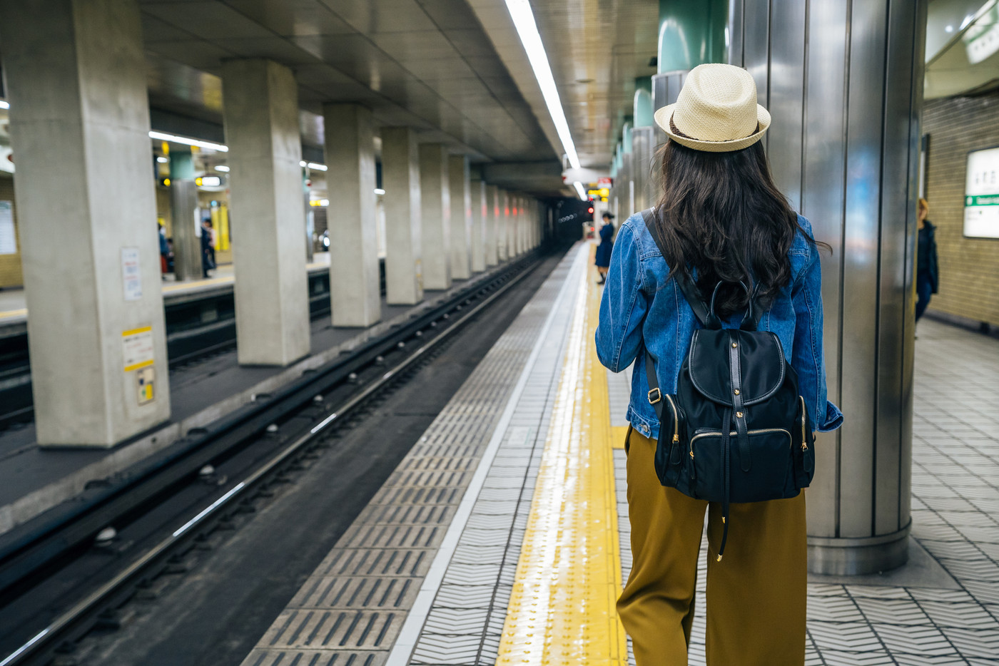 female backpacker walking in subway station