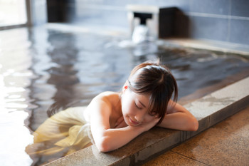 Cute woman relaxing in onsen
