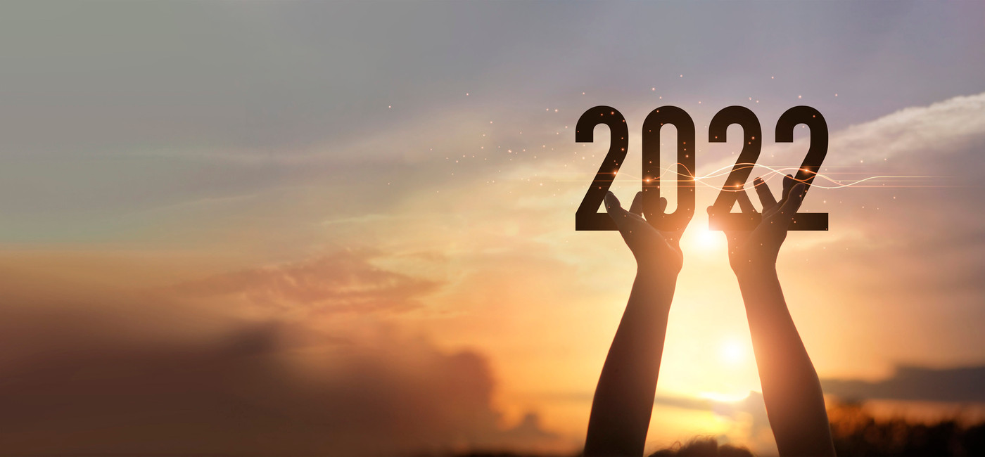 Hands holding of new year 2022 silhouette against on the sunset background, Happy New Year concept.