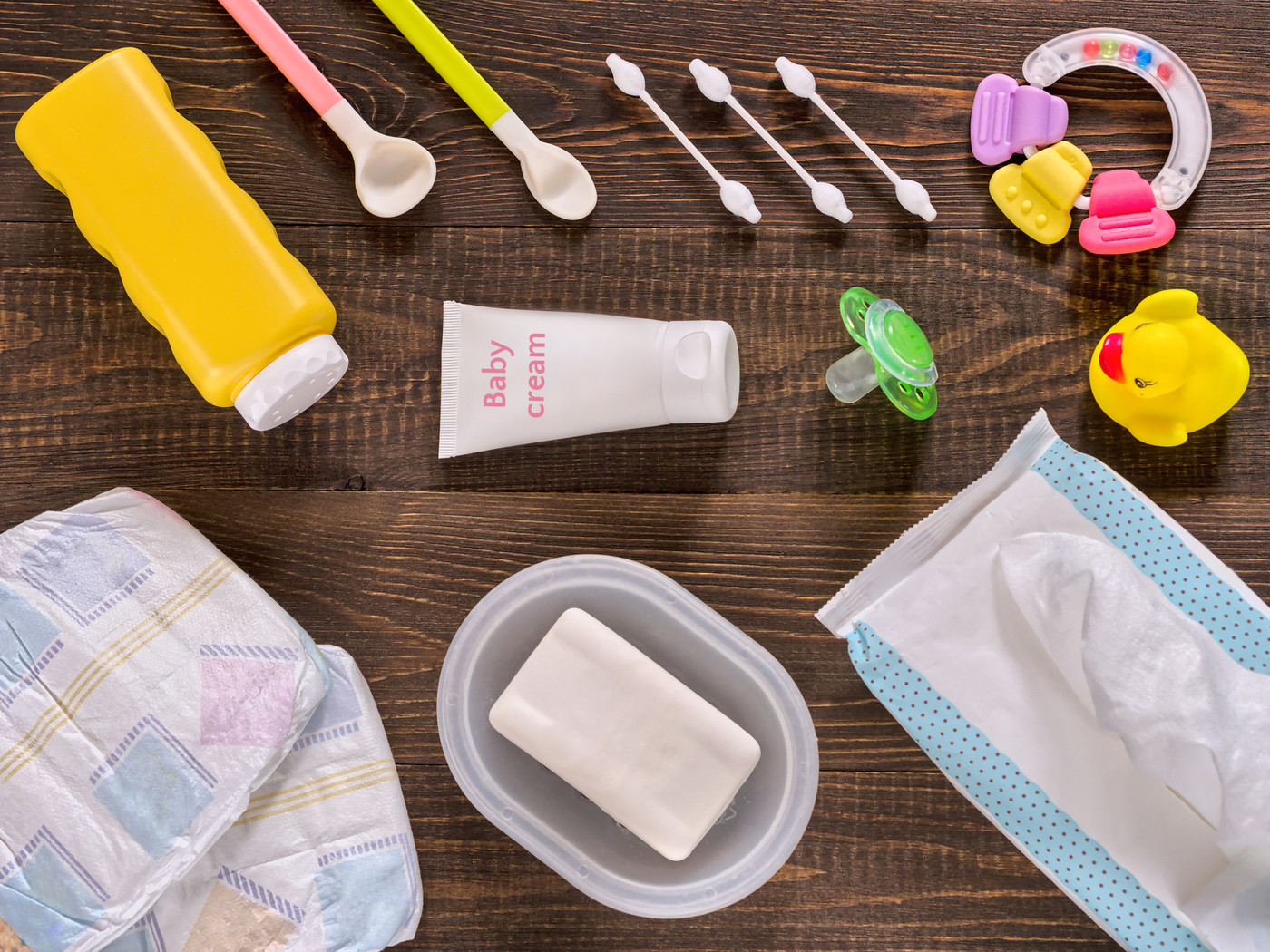 Baby essentials and care on dark wooden table