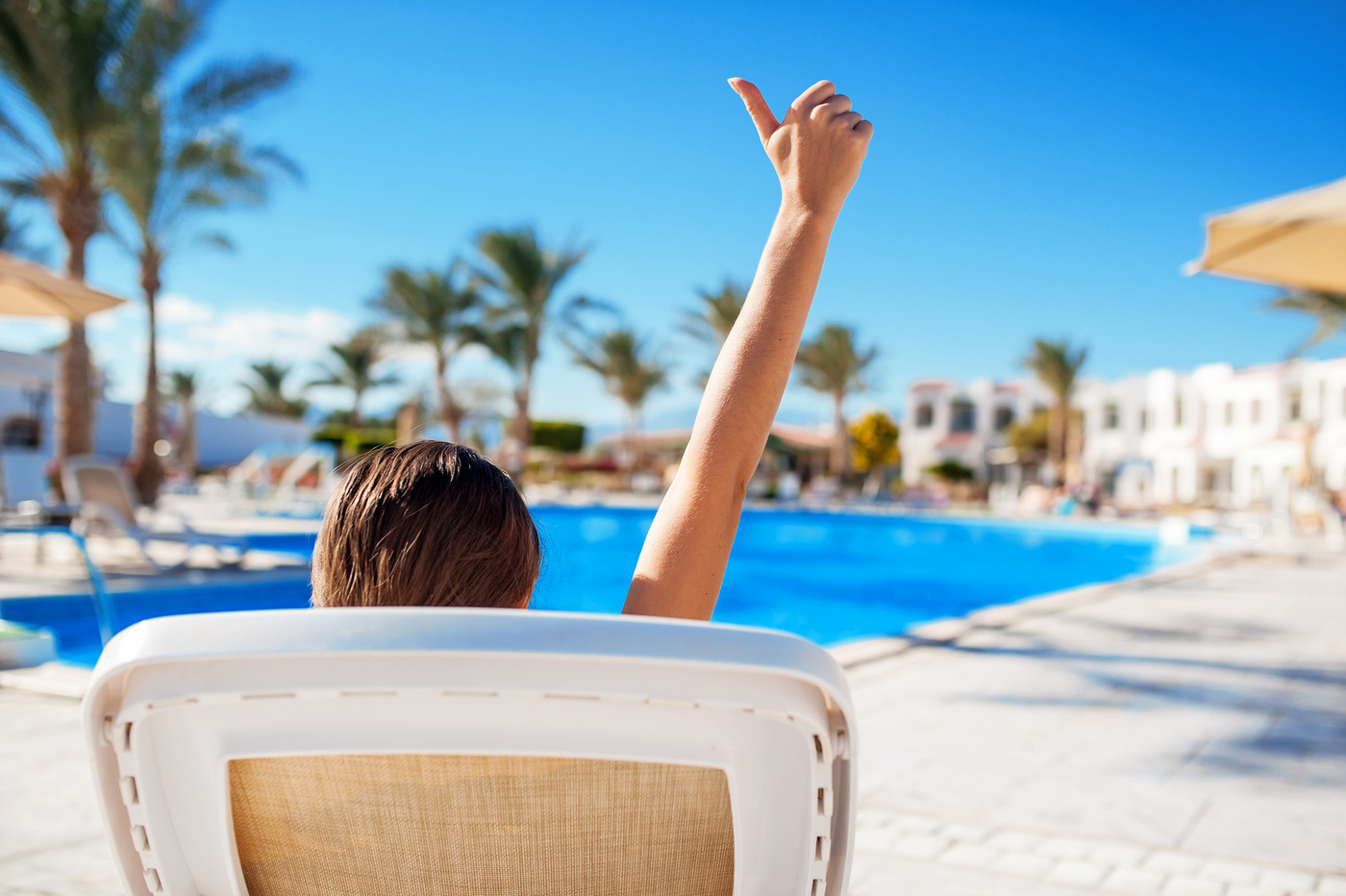 woman lying on a lounger by the pool at the hotel