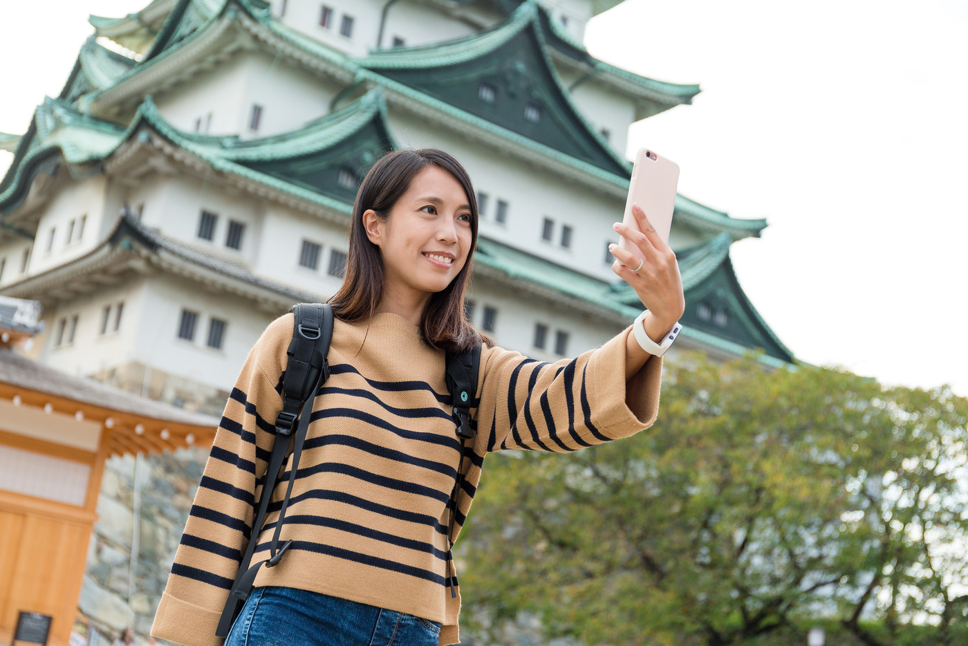 Woman travel in Nagoya castle and taking selfie