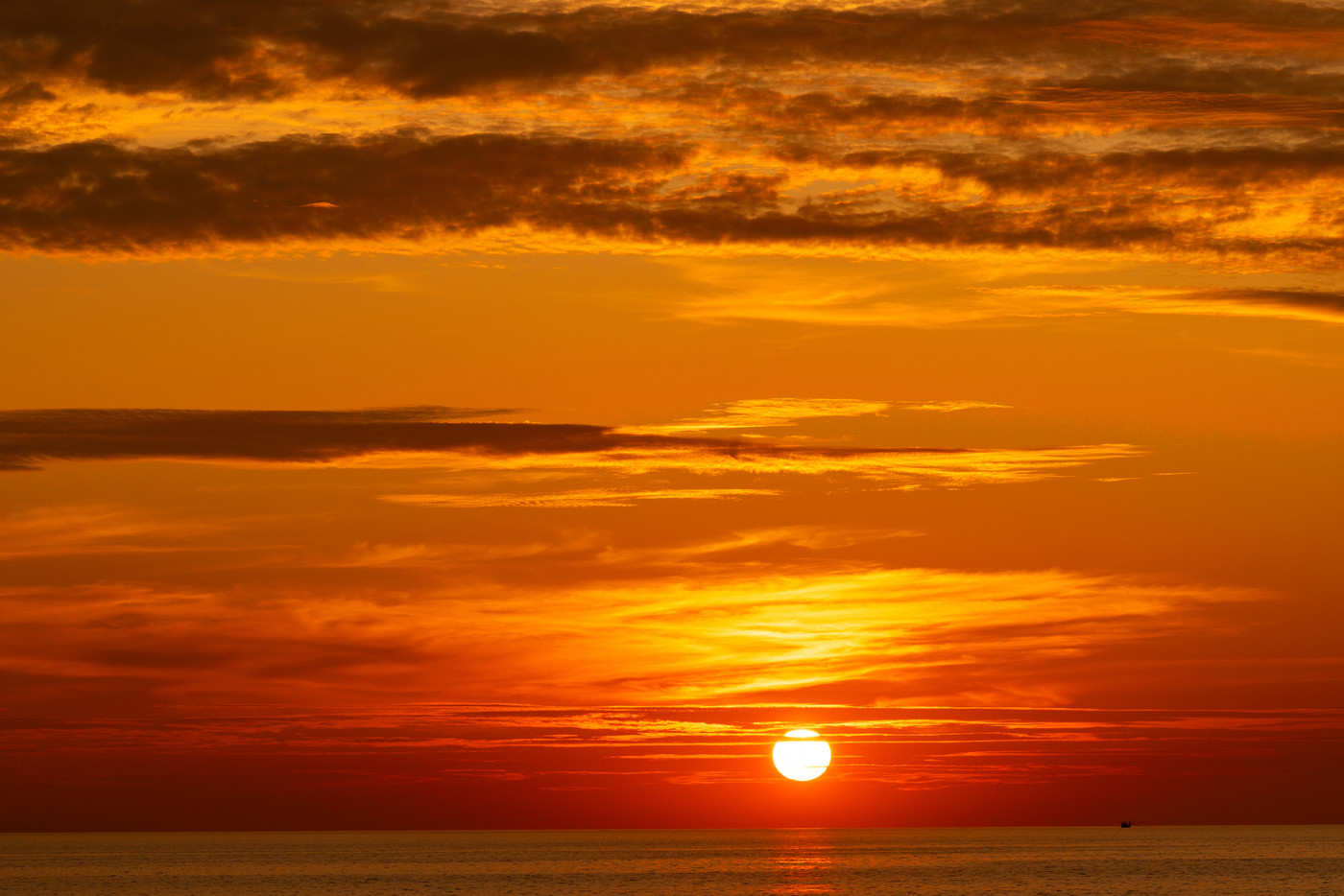 Beautiful light nature red sun in the golden sky and dark clouds seascape,Landscape nature background Golden sun