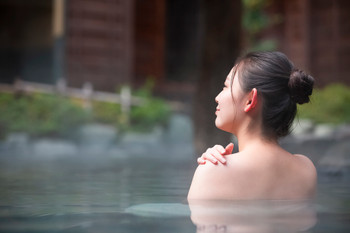 A woman enjoying an open-air bath