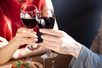 Couple Hands of a man and woman toasting with wine