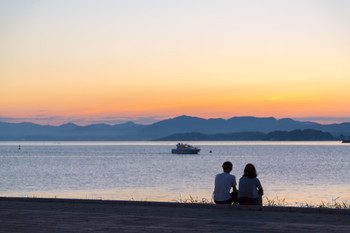 A couple looking at Lake Shinji at sunset