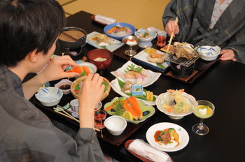 Men and women enjoying meal at a onsen inn