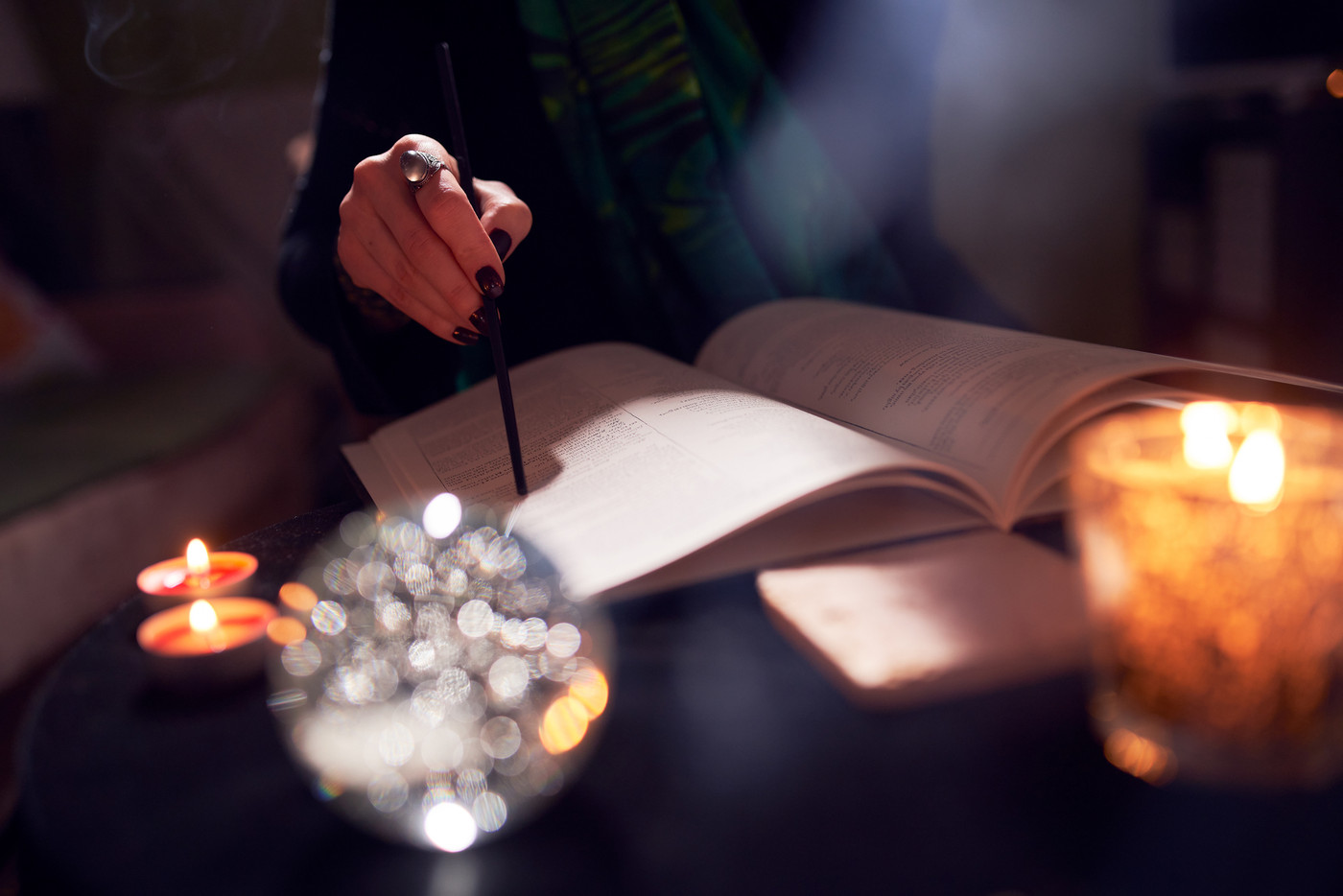 Female fortune-teller's hands, predictions books, predictions ball