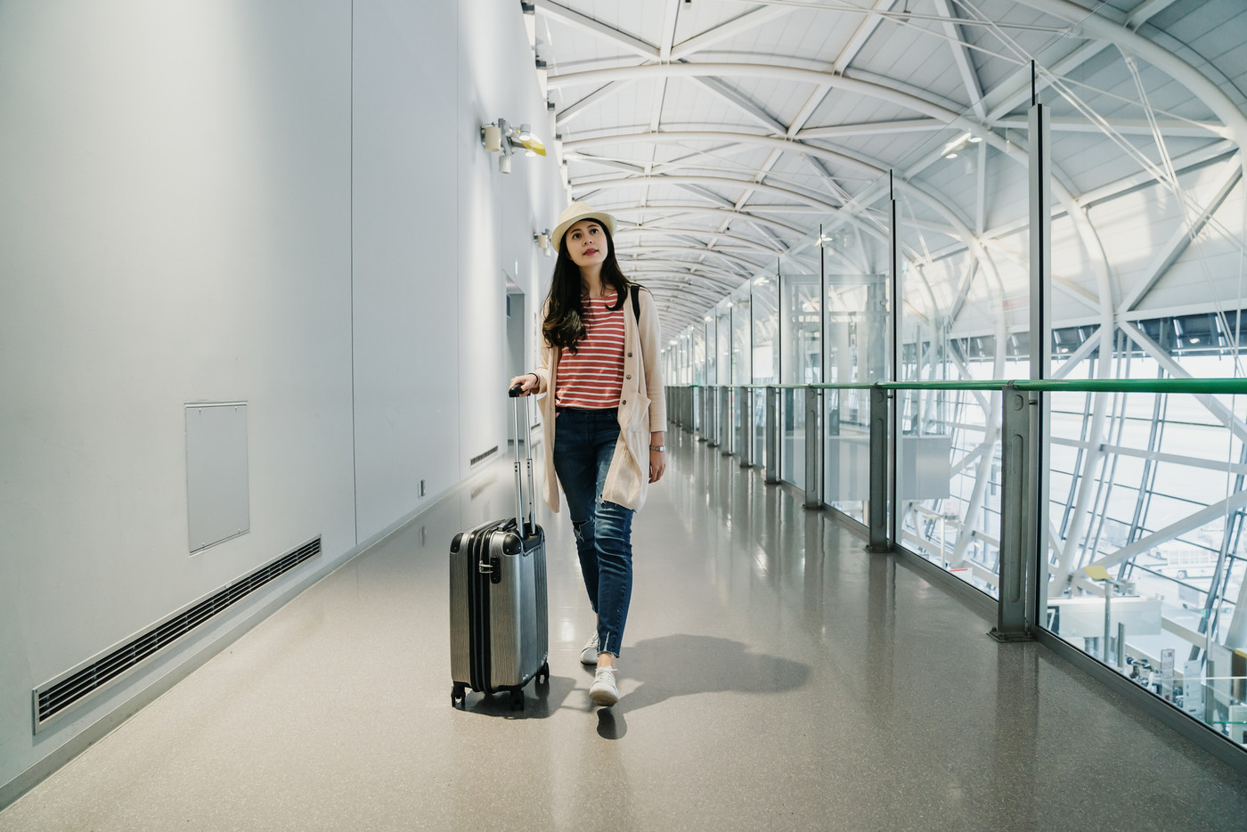 woman traveling and walking in airport.