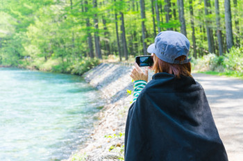 Female traveler taking a photo with smart phone