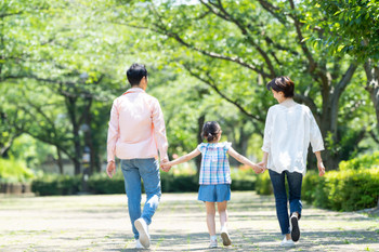 Parent and child walking park elementary school student family image