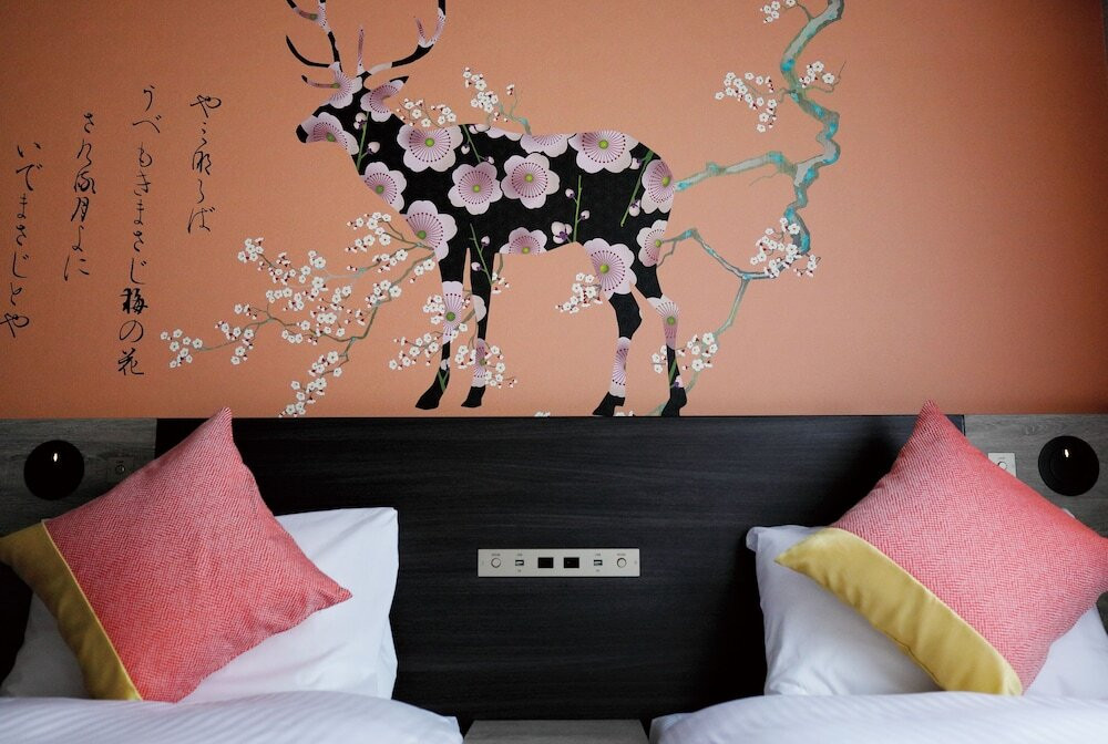 ホテルの部屋に到着して伸びをする若い女性