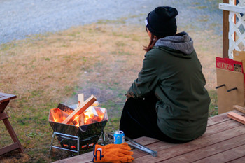 A woman making a bonfire