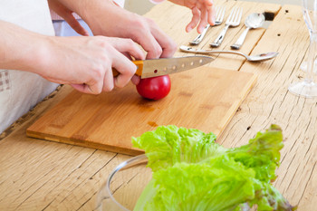 A young couple cooking, close-up