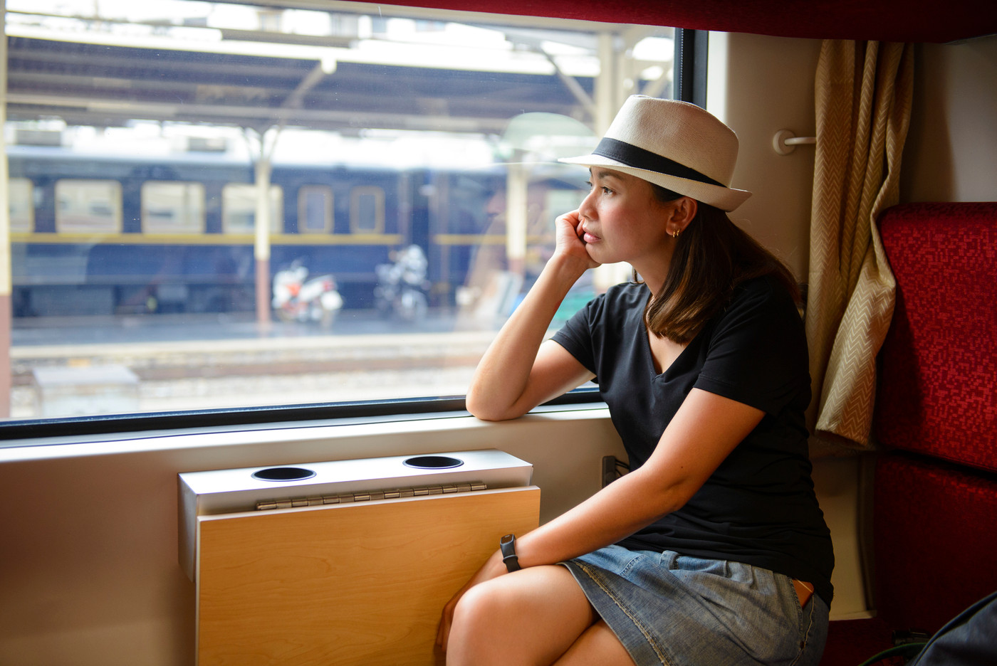 Young woman traveling looking out the window while