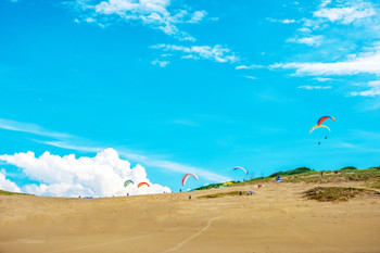 tottori sand dunes paragliding blue sky