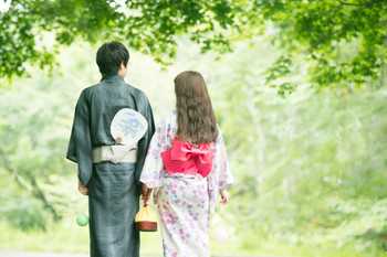 Rear view of couple holding hands in yukata