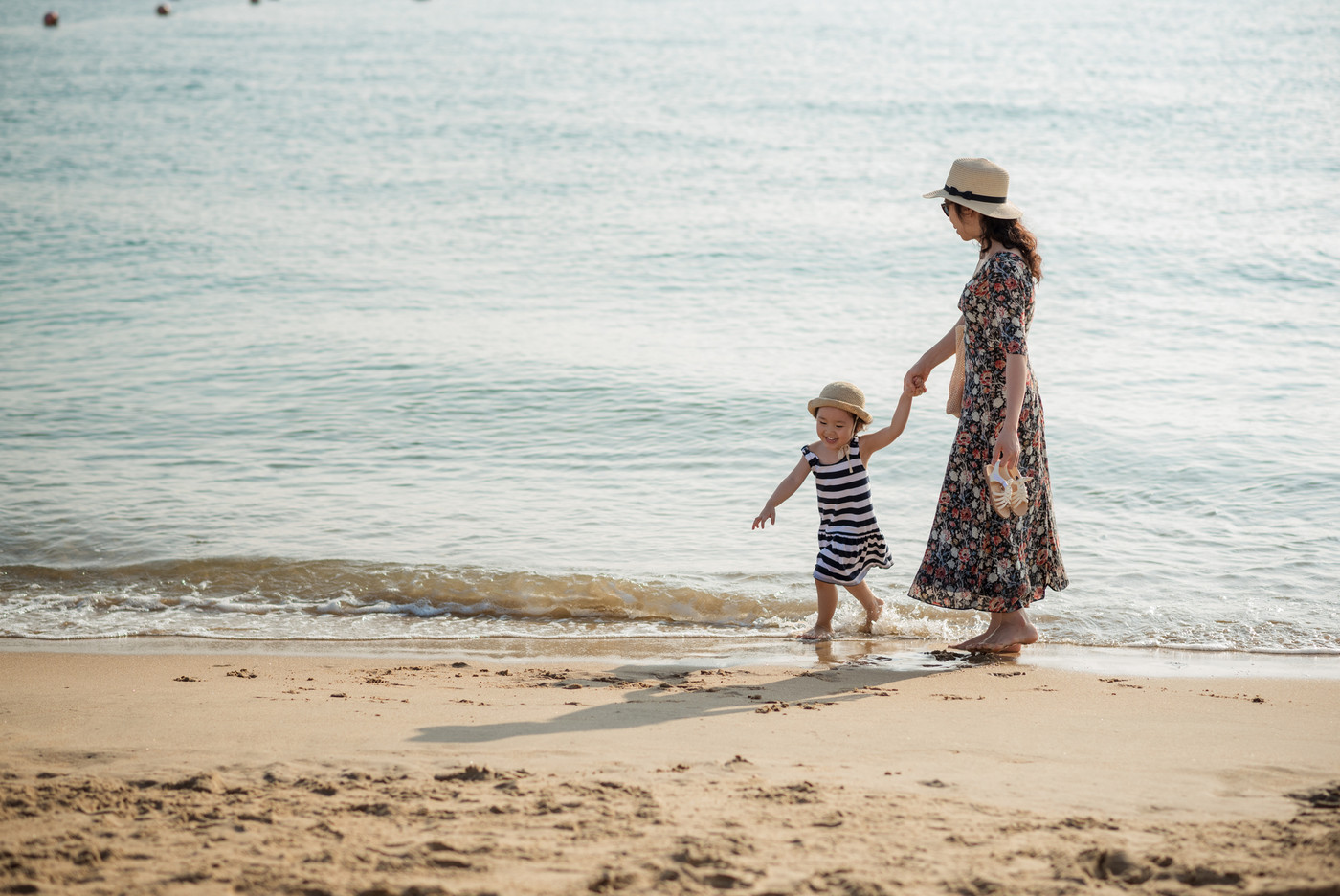 Mother and daughter having fun on the beach