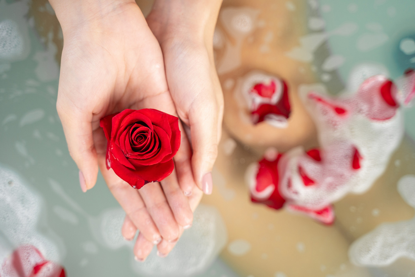 Young Caucasian lady taking a flower bath