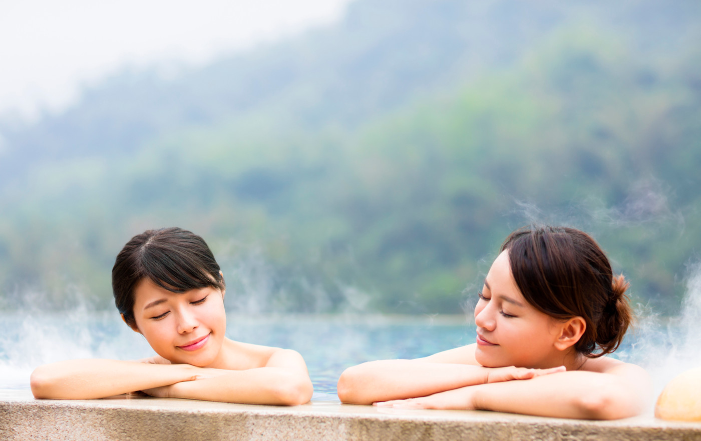 happy young woman relaxing in  hot springs