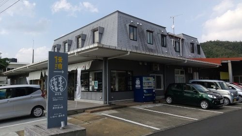 写真左側がメイン車道で、車が並んでいる右隅が入口