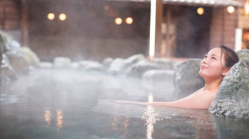 A woman enjoying an open-air bath