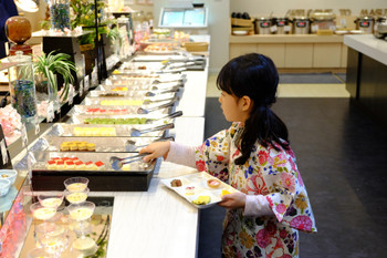 A child taking a cake at the buffet venue