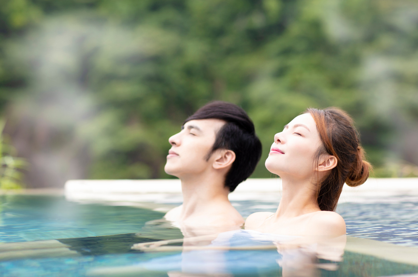 Young couple relaxing in hot springs