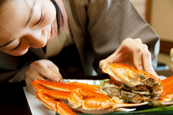 A woman's hands opening a crab shell