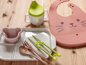 Stock Photo | A set of baby food apron, auxiliary chopsticks and tableware for children