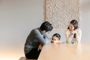 Parents and children relaxing indoors