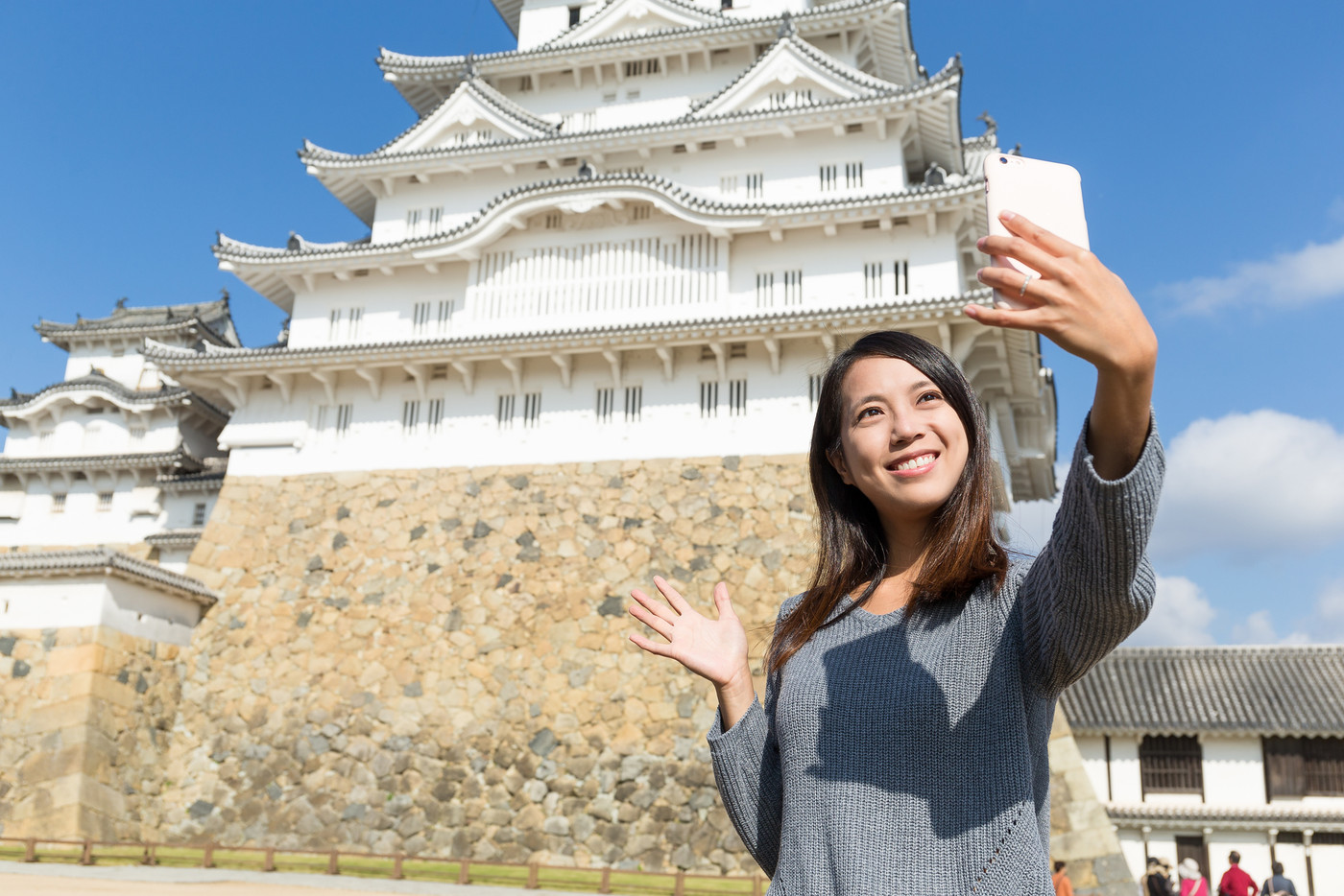 Woman taking selfie by cellphone in Himeji Castle