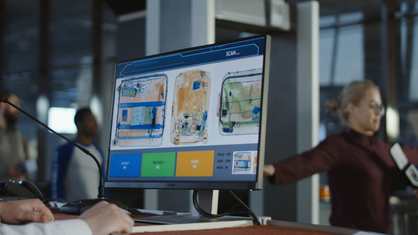Employee exploring baggage through x-ray
