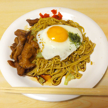 「食い道楽 本店」料理 76533 ホルモン焼きそば（￥600）。半熟玉子が乗り、味噌風味のホルモン、福神漬に柔らかめの麺が特徴