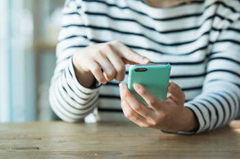 A woman with a smartphone at hand