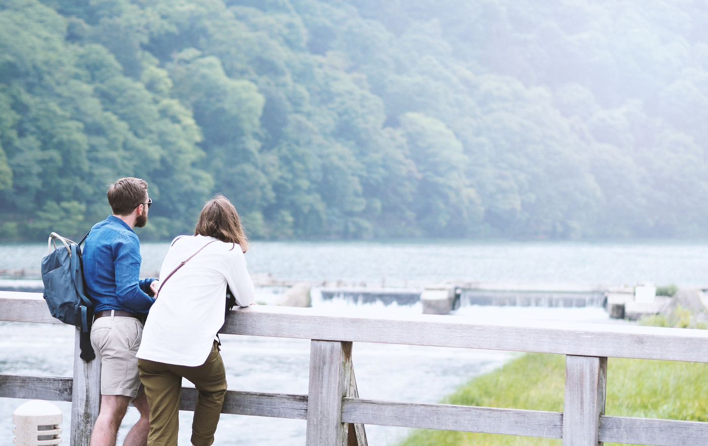 Couple casual traveller standing on bridge 