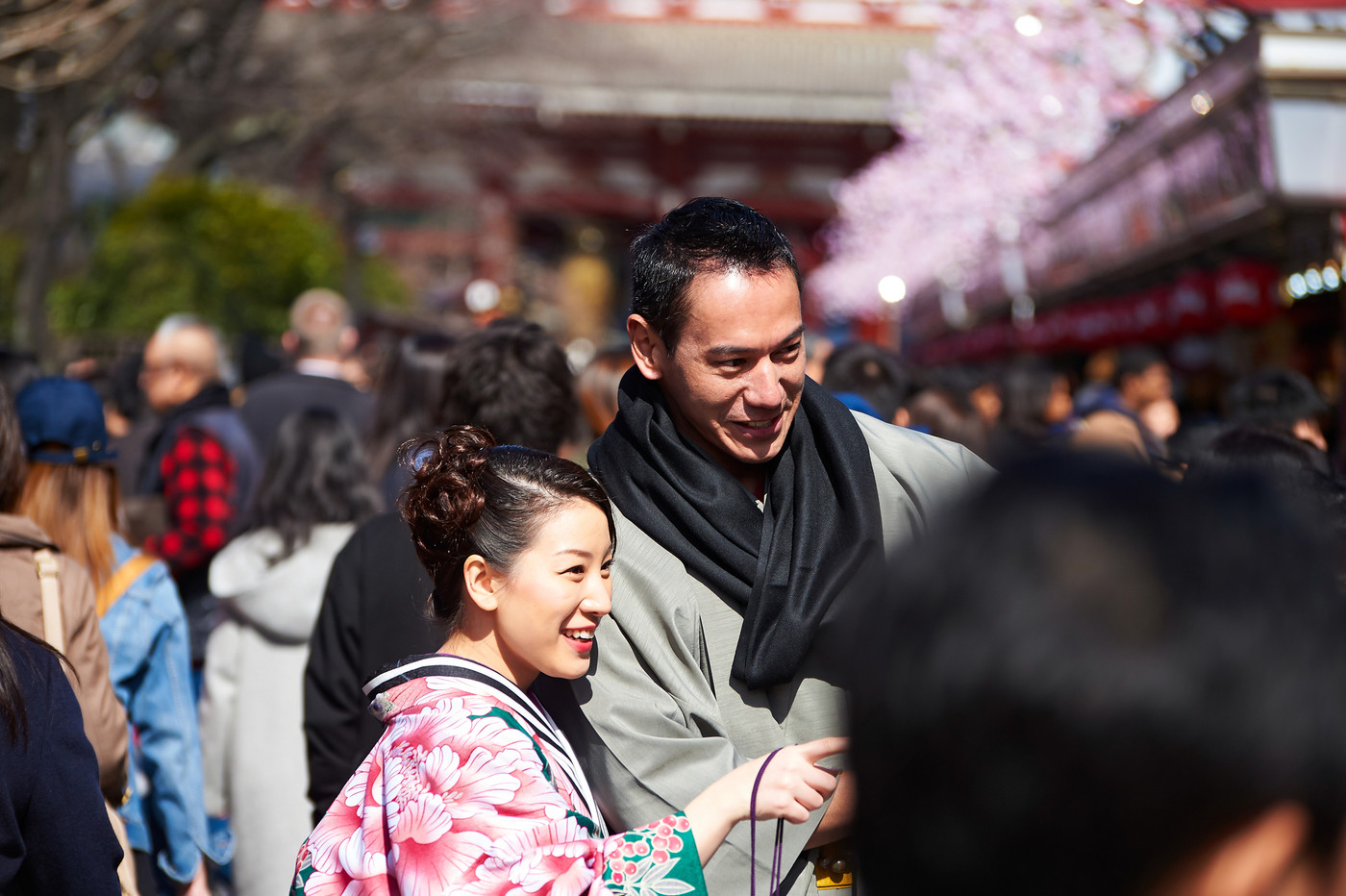 A happy couple wearing kimono is excited about something at downtown