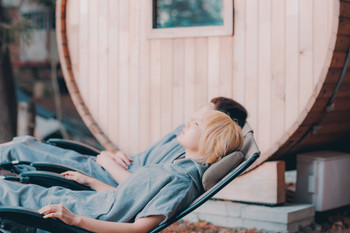 Couple relaxing outside in sauna