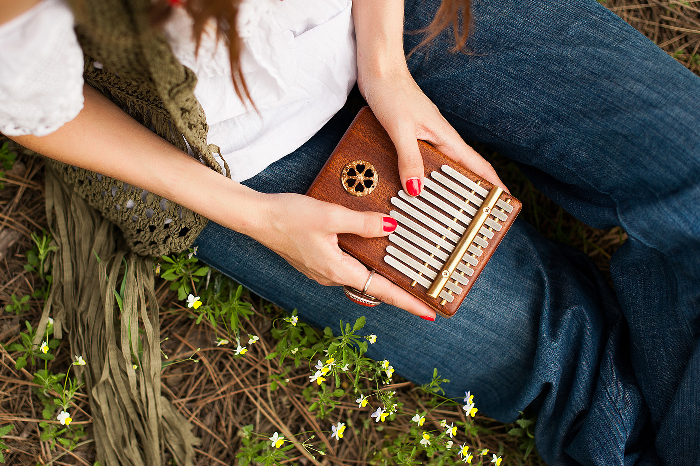 Woman holding kalimba in her hands and playing
